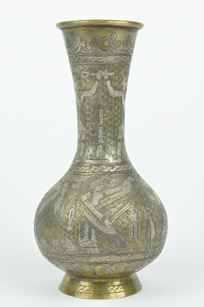 A MIDDLE EASTERN SILVERED BRONZE VASE: A MIDDLE EASTERN SILVERED BRONZE VASE The silvered bronze vase of typical baluster form and having archaic Egyptian motifs depicting kneeling pharaohnic figures, ankh, serpents, and lotus over an inte