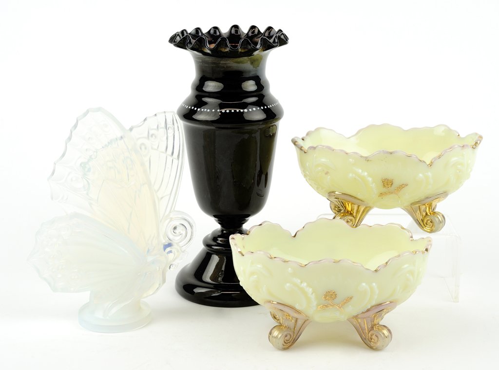 AN ASSEMBLED COLLECTION OF ART GLASS 4 pieces total: AN ASSEMBLED COLLECTION OF ART GLASS Comprising a Bristol enameled amethyst glass vase, a Sabino opalescent glass butterfly figure, signed to base Sabino Paris, and two Northwood custard glass footed 