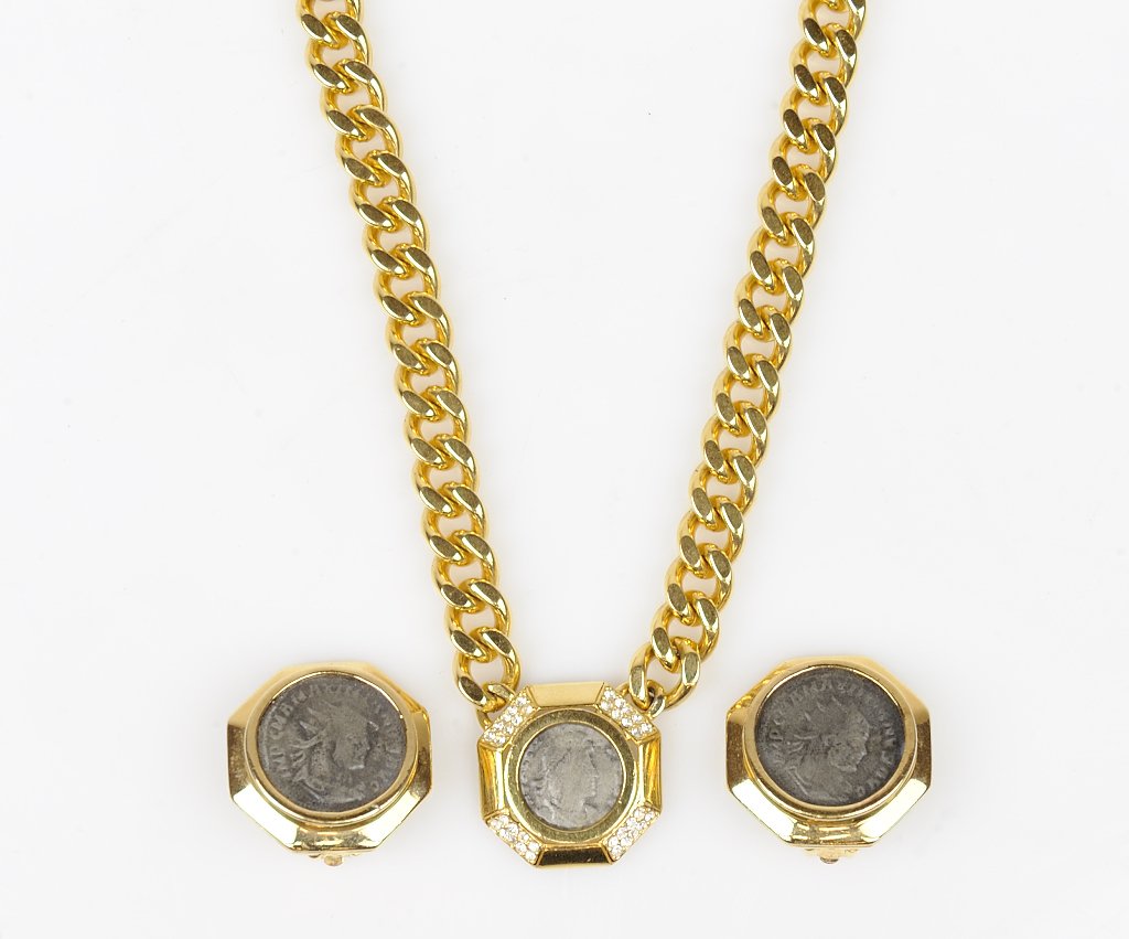 A CINER GOLDTONE ROMAN COIN NECKLACE & EARRINGS 3: A CINER GOLDTONE ROMAN COIN NECKLACE & EARRINGS The set features a gold tone heavy chain necklace and earrings with roman coins. Signed "CINER". 3 pieces total Length of necklace 15 inches.