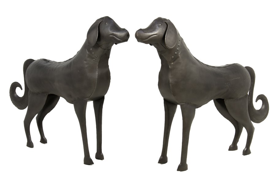 A PAIR OF IRON DOG FIGURES: A PAIR OF IRON DOG FIGURES Each modeled as a standing dog, the neck with applied beaded decoration. H 35½ x W 41 x D 8½ inches.