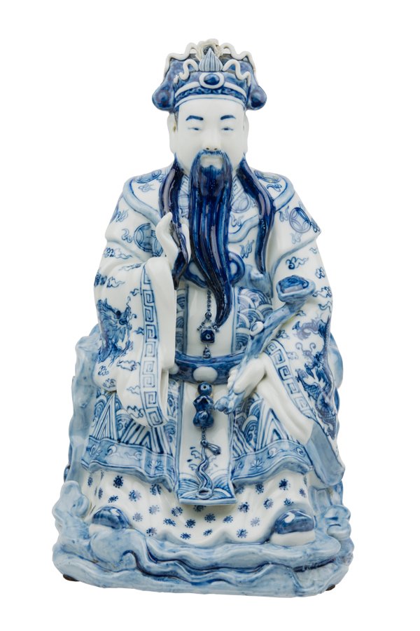 A CHINESE BLUE AND WHITE PORCELAIN SEATED FIGURE: A CHINESE BLUE AND WHITE PORCELAIN SEATED FIGURE Depicting a seated sage on a naturalistic throne, a ruyi scepter in one hand, raised on the integral rockery and clouds base. H 15¼ x W 9¼ x D 8¼ in