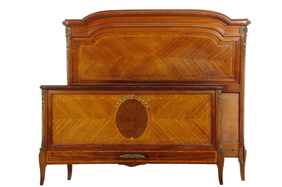 A FRENCH TRANSITIONAL STYLE BED: A FRENCH TRANSITIONAL STYLE BED The bed having a domed top rail with gilt metal mounts over the parquetry inlaid back panel, raised on slight sabre legs. Comprising headboard, footboard and side rails