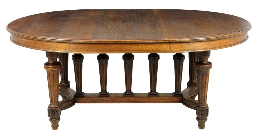 A FRENCH LOUIS XVI STYLE DINING TABLE: A FRENCH LOUIS XVI STYLE DINING TABLE The dining table having an oval top, over the plain frieze, raised on cylindrical tapering fluted legs, joined by H-form stretcher, surmounted with a series of su