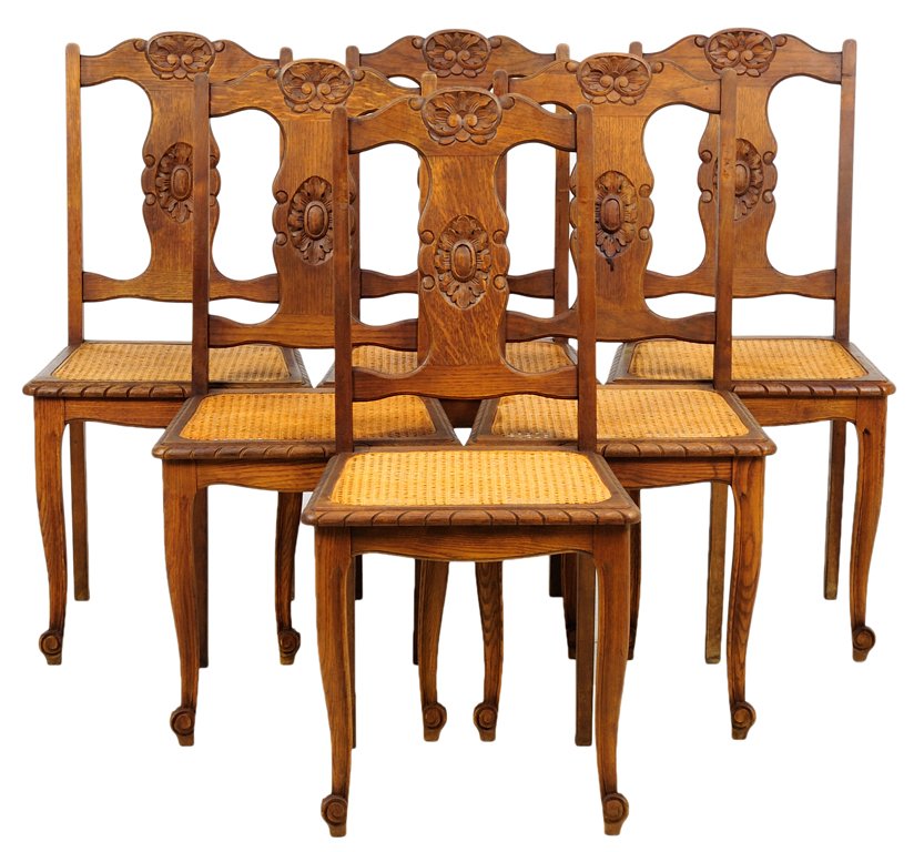 A SET OF SIX FRENCH PROVINCIAL SIDE CHAIRS: A SET OF SIX FRENCH PROVINCIAL SIDE CHAIRS Each chair having a curved crest rail centered with a carved shell, over the vertical carved backsplat, above the trapezoidal caned seat, raised on slight ca
