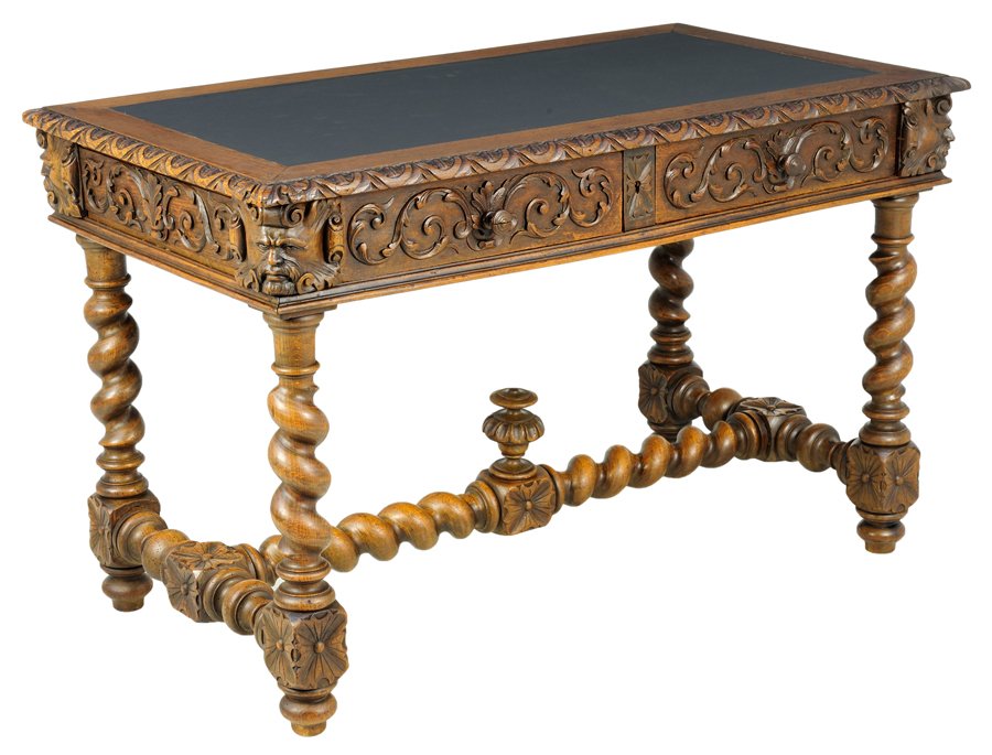 A RENAISSANCE REVIVAL OAK BUREAU PLAT: A RENAISSANCE REVIVAL OAK BUREAU PLAT The bureau plat having a rectangular leather inset top within a carved border over two short drawers carved with griffin mask and scrolling leaf decoration, raise