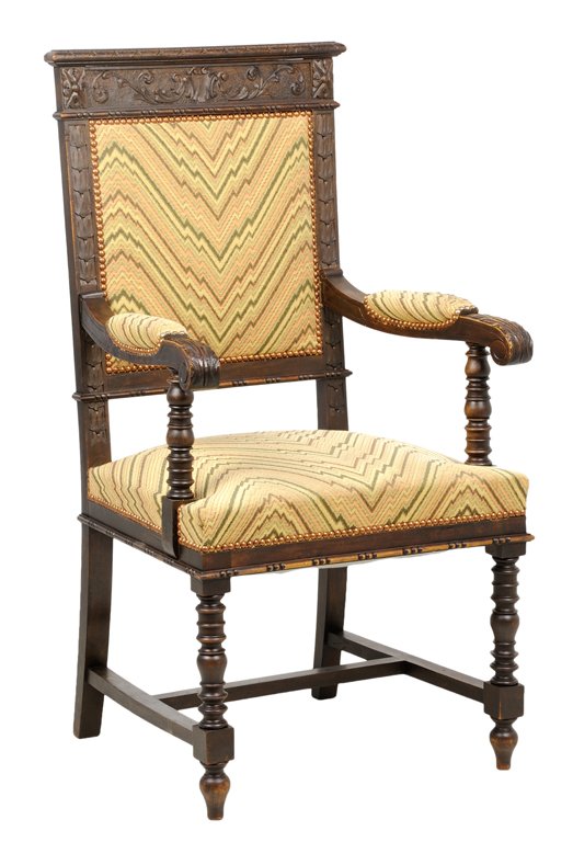 A RENAISSANCE REVIVAL HALL CHAIR: A RENAISSANCE REVIVAL HALL CHAIR The hall chair having a straight crest rail over the carved frieze, above the upholstered back and seat, with nailhead border, within open arms, raised on turned fore 