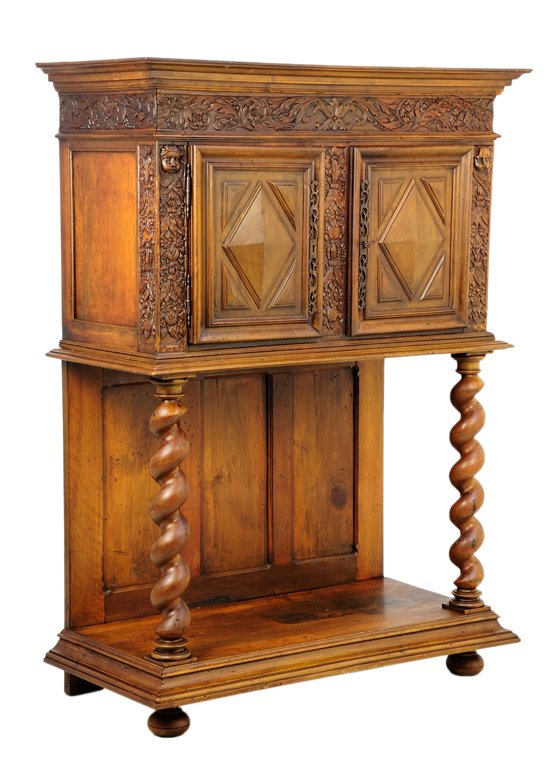 A RENAISSANCE REVIVAL CABINET ON STAND: A RENAISSANCE REVIVAL CABINET ON STAND The cabinet on stand having a flared cornice over the foliate carved frieze, above two paneled doors, flanked by mask carved decoration, raised on barley twist s