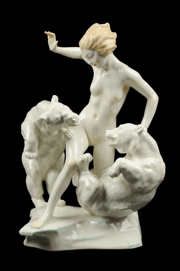A BAVARIAN PORCELAIN FIGURAL GROUP: A BAVARIAN PORCELAIN FIGURAL GROUP Hutschenreuther, Selb, after a model by K. Tutter, depicting a nude lady between fighting bears, marked to base. H 12 x W 9½ x D 8¼ inches.