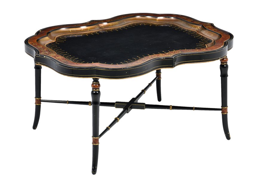 A VICTORIAN STYLE PAINTED TEA TRAY ON STAND: A VICTORIAN STYLE PAINTED TEA TRAY ON STAND The tea tray of cartouche form with a gilt a painted border, raised on tapering cylindrical legs, joined by an X-form stretcher. H 19¼ x W 38 x D 29¼ inch