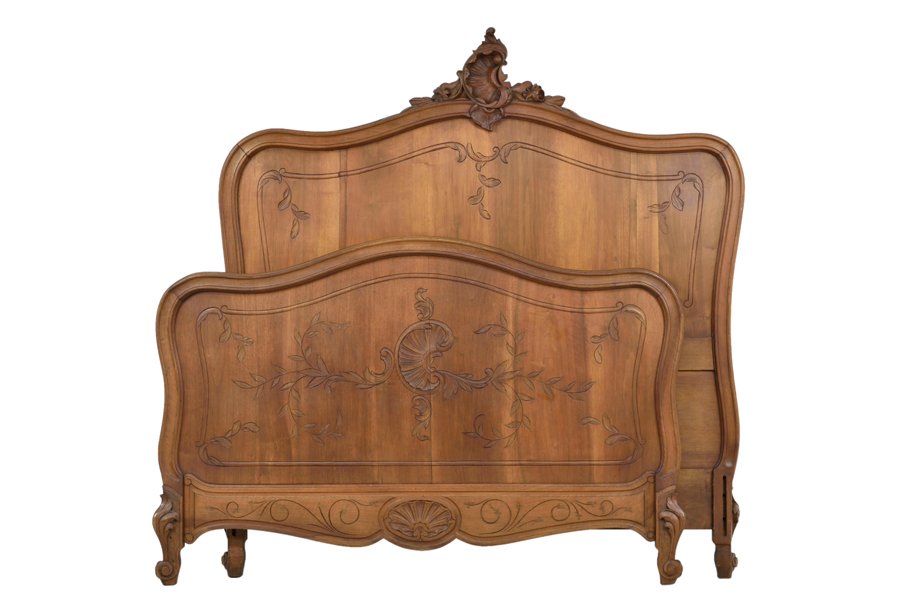 A FRENCH LOUIS XV STYLE BED: A FRENCH LOUIS XV STYLE BED The bed with carved rocaille and leaf decoration to top rail of headboard, raised on scrolled legs. Comprising headboard, footboard and side rails. Width 53 inches.