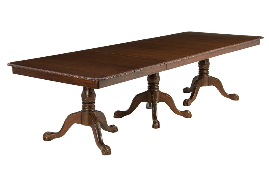 A CONTINENTAL STYLE PEDESTAL DINING TABLE: A CONTINENTAL STYLE PEDESTAL DINING TABLE The table having a rectangular top within the gadrooned border, raised on three pedestal supports, on tripartite legs ending in claw and ball feet. H 30½ x W