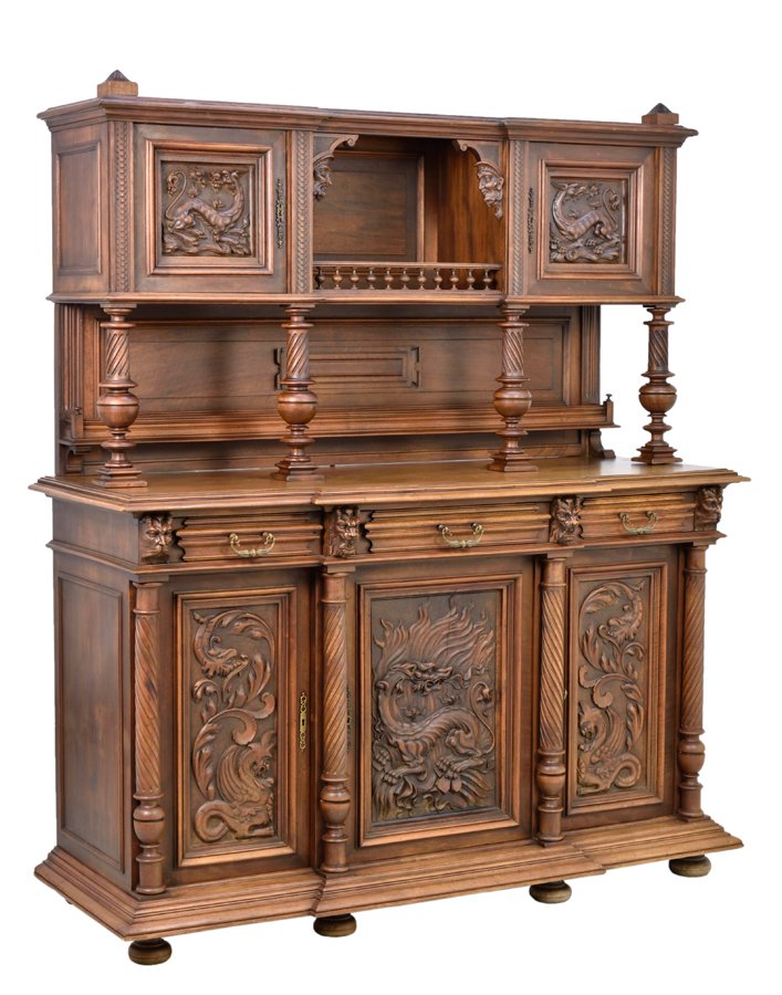 A RENAISSANCE REVIVAL SERVER: A RENAISSANCE REVIVAL SERVER The serve having a flared cornice above two paneled doors carved with griffin decoration centered with a shelf with a spindled gallery, raised on four baluster form suppor