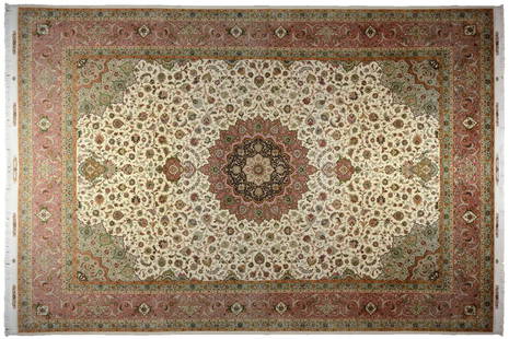 A TABRIZ WOOL AND SILK RUG: A TABRIZ WOOL AND SILK RUG The rug having a central foliate medallion on an ivory ground with repeating foliate decoration, within multiple borders, and fringe to both ends. 16ft 8in x 11ft 4in