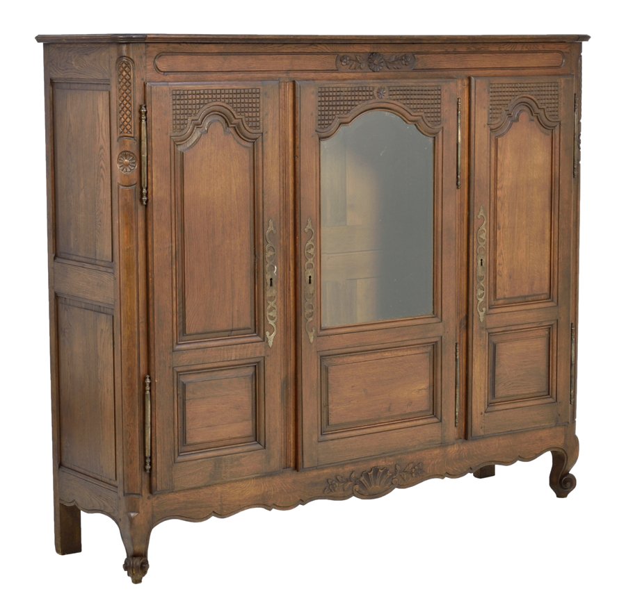 A FRENCH PROVINCIAL STYLE CABINET: A FRENCH PROVINCIAL STYLE CABINET The cabinet having a rectangular top over the conforming case, above a central glazed door flanked by paneled doors, above the shell carved apron, raised on scrolled 