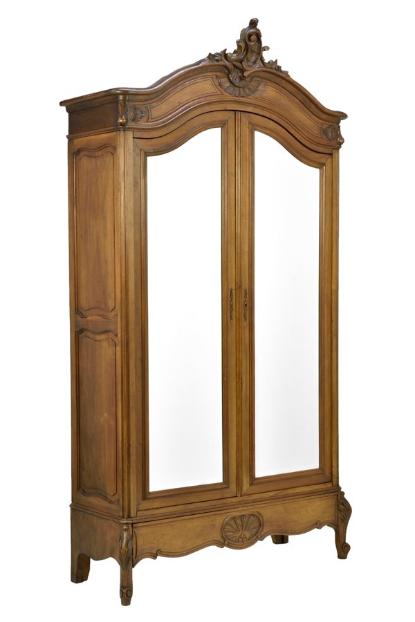 A FRENCH LOUIS XV STYLE ARMOIRE: A FRENCH LOUIS XV STYLE ARMOIRE The armoire having a carved acanthus leaf crest above the domed cornice, over the conforming case fitted with two mirror paneled doors, over the serpentine apron, raise