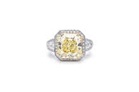 AN IMPORTANT 7.02 CARAT FANCY YELLOW CUSHION CUT