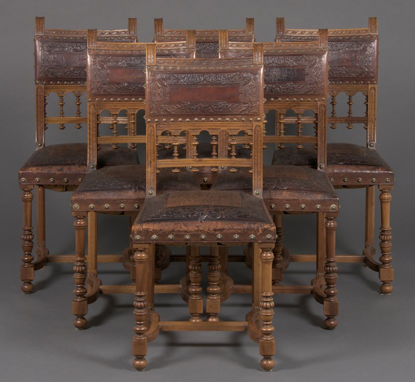 A SET OF TEN RENAISSANCE REVIVAL FARTHINGALE CHAIRS: A SET OF TEN RENAISSANCE REVIVAL FARTHINGALE CHAIRS Each chair having a straight crest rail over a tooled leather backsplat and seat with nailhead border, raised on barley twist legs, joined by a seri