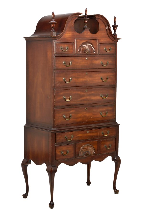 A QUEEN ANNE STYLE MAHOGANY HIGHBOY: A QUEEN ANNE STYLE MAHOGANY HIGHBOY The highboy having a broken arch pediment centered with an urn form finial flanked by a pair of finials, fitted with two short drawers over four long graduated draw