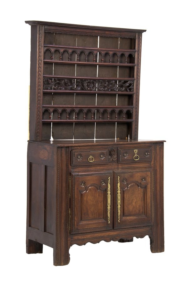 A FRENCH PROVINCIAL OAK WELSH CUPBOARD: A FRENCH PROVINCIAL OAK WELSH CUPBOARD 18th century The Welsh cupboard having a flared cornice over a series of galleried shelves, above the rectangular top and conforming case, fitted with two short 