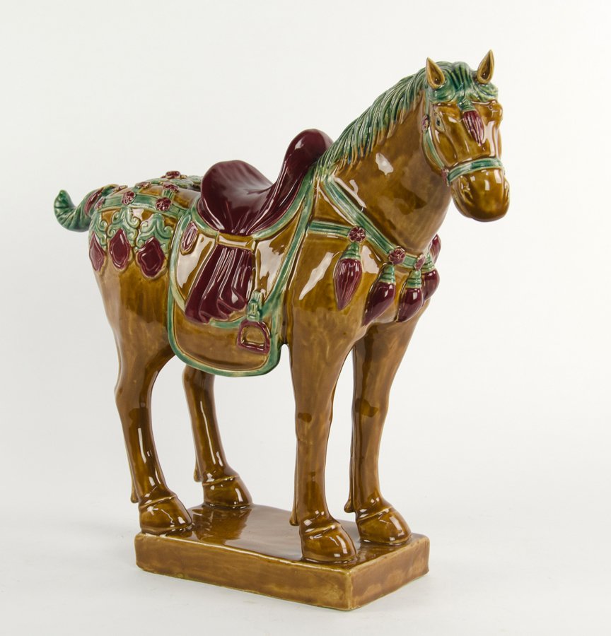 A CHINESE TANG DYNASTY STYLE CERAMIC MODEL OF A HORSE (1 of 2)