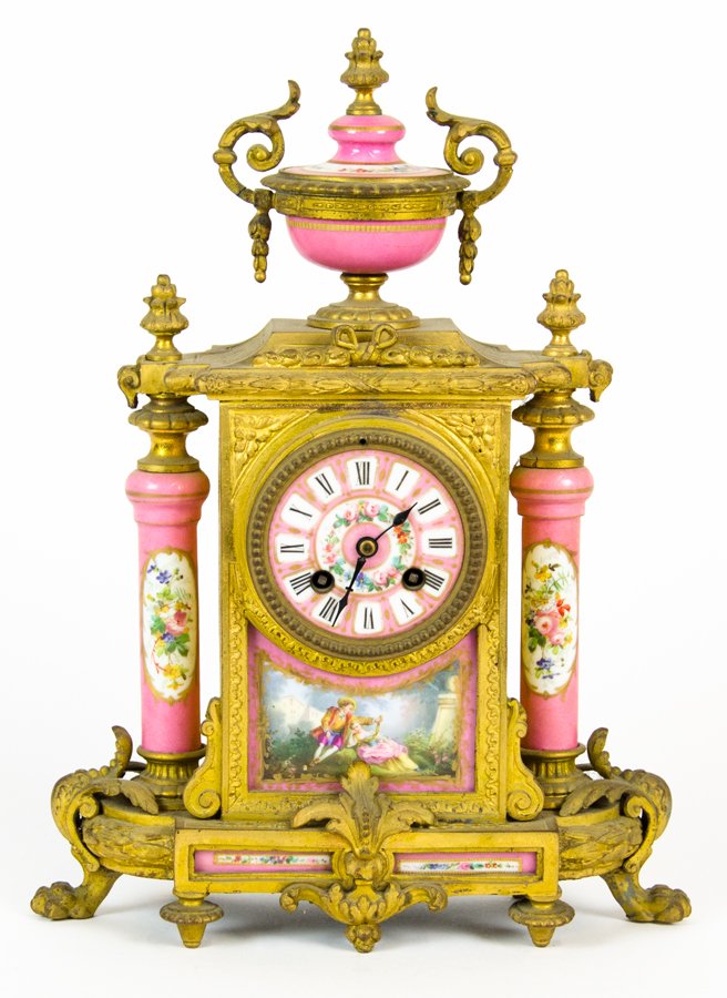 A FRENCH ENAMEL AND ORMOLU MOUNTED STRIKING MANTEL: A FRENCH ENAMEL AND ORMOLU MOUNTED STRIKING MANTEL CLOCK 20th century With pink enamel roman dial centering an ormolu mounted case, surmounted by an urn form finial, having two enamel columns with flo