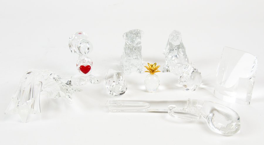 A COLLECTION OF BACCARAT, SEUBEN, WATERFORD AND VAL ST.: A COLLECTION OF BACCARAT, SEUBEN, WATERFORD AND VAL ST. LAMBERT CRYSTAL ORNAMENTS Comprising a Baccarat Spaniel and 'Snoopy Holding Heart', a Steuben rabbit, modeled in a crouched position, a twisted 