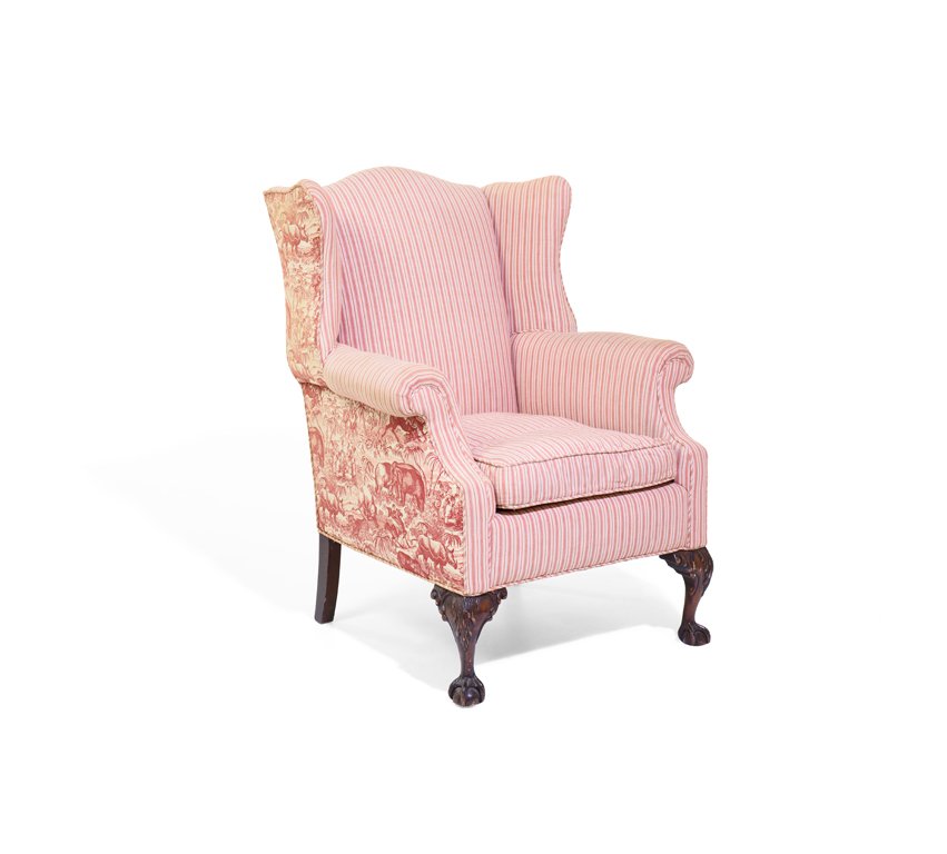 A GEORGIAN STYLE MAHOGANY WINGBACK ARMCHAIR: A GEORGIAN STYLE MAHOGANY WINGBACK ARMCHAIR 20th century The wingback armchair having a domed crest rail over the upholstered back, sides and seat, raised on cabriole fore legs, ending in claw and bal