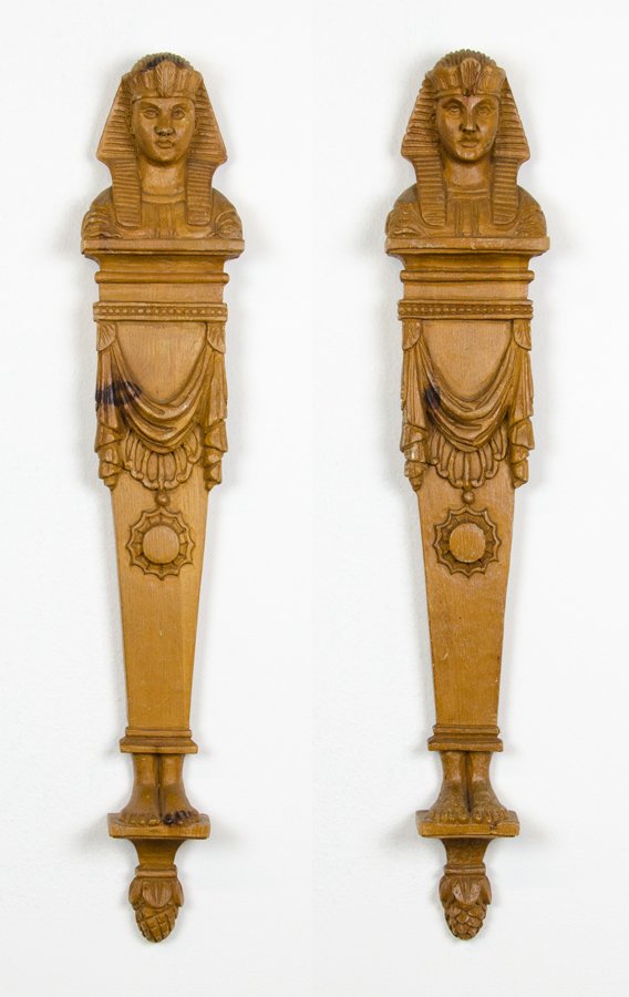 A PAIR OF EGYPTIAN REVIVAL CARVED WOOD WALL APPLIQUES: A PAIR OF EGYPTIAN REVIVAL CARVED WOOD WALL APPLIQUES Second half 20th century Each modeled as the bust of a pharaoh on a tapering plinth with swag and medallion detail. H 29 inches