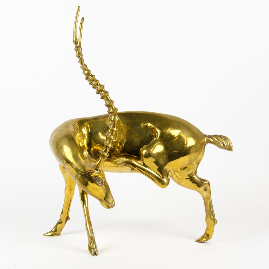 A BRASS MODEL OF AN ANTELOPE: A BRASS MODEL OF AN ANTELOPE Modelled standing with head turned inward, with a hind leg raised as if to scratch behind its ear. H 22 inches Provenance: Property from the Collection of Greg Miller, Hou