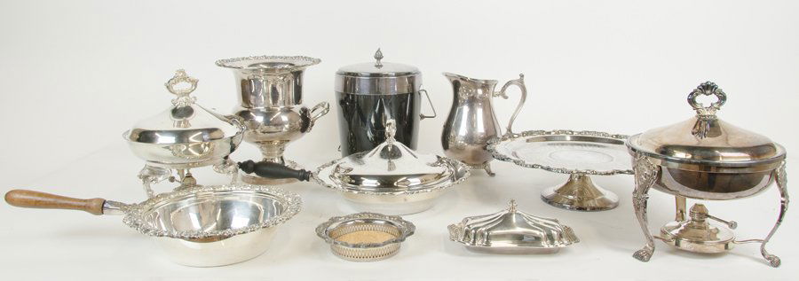 A COLLECTION OF SILVER-PLATE TABLE ARTICLES: A COLLECTION OF SILVER-PLATE TABLE ARTICLES 20th Century Comprising two serving tureens, each with a wood handle, one lidded, a footed tazza and a reticulated wine coaster by Poole, two chafing dishes