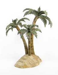 A DECORATIVE MODEL OF THREE PALM TREES ON AN ISLAND