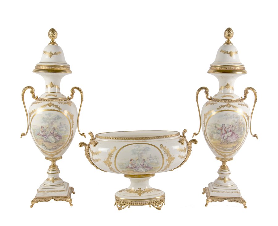 A CONTINENTAL STYLE PORCELAIN GARNITURE: A CONTINENTAL STYLE PORCELAIN GARNITURE 20th Century The garniture comprising a center bowl and a pair of lidded urns. Each urn having a gilt painted acorn finial over the baluster form body having tr