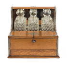 AN ENGLISH BRASS BOUND OAK TANTALUS