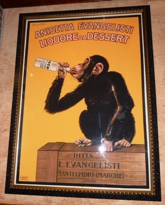 Framed French Poster: Anisette Evangelisti Liquore de Dessert. Foxing throughout. 48 1/2"x 66"Mounted under plexi