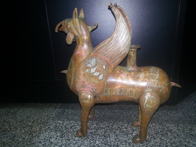 Islamic Style Silver inlaid Bronze Griffin @22: Wonderful Unique Silver inlaid Bronze Griffin all around with Silver inlaid Islamic Calligraphic writing and figures animal pegasus . The size is ( 24 c m ) 9 1/2 " The Weight is 2 2.35 KG
