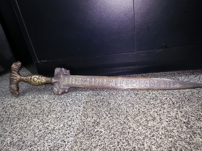 Unique Islamic Style Silver Inlaid Bronze Sword @33: Beautiful Islamic Style Silver Inlaid Bronze Sword . The handle has 2 lion and 2 Ram Heads With Islamic Writing Blade at both Sides . The Size is 55 C M , Weight is 950 grams .