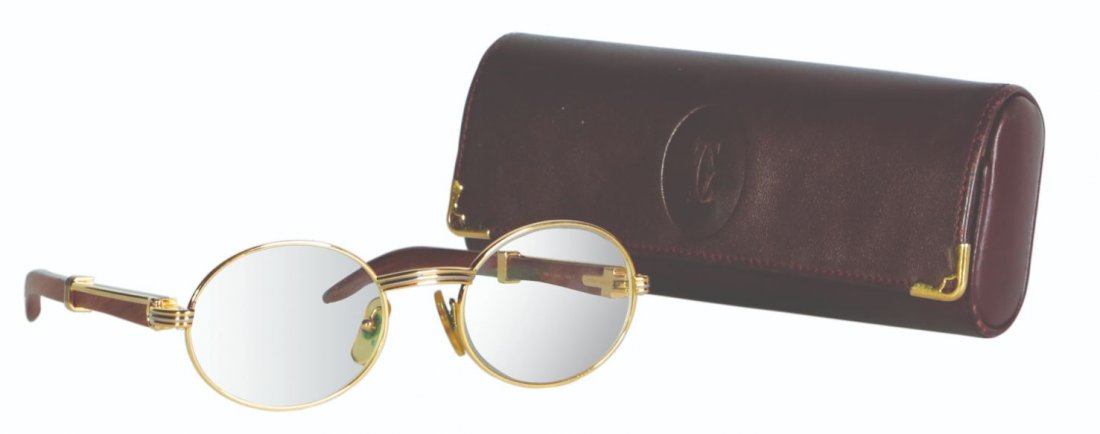 A Pair of Cartier Eyeglasses with Case: glasses: 18 carat goldcase: wood17” x 29” x 17”(43 cm x 74 cm x 18 cm)