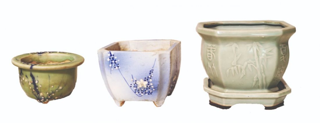 Three Footed Planters with Floral Motifs: a) H: 3 1/2” (9 cm) D: 6” (15 cm) b) 5” x 6” x 6” (13 cm x 15 cm x 15 cm) c) 6 1/2” x 7 1/2” x 7 1/2” (17 cm x 19 cm x 19 cm)
