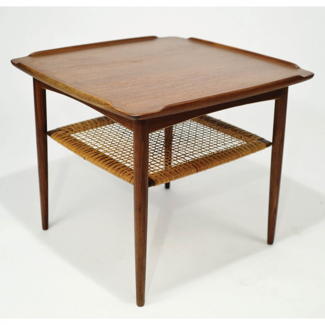 Danish Teak Side Table Poul Jensen for Selig: Danish Teak Side TablePoul Jensen for Selig Vintage Teak Wood Square Table Designedby Poul Jensen for Selig, Denmark. Wicker2nd tier in good condition. Dimensions H20.5 W 24 inches