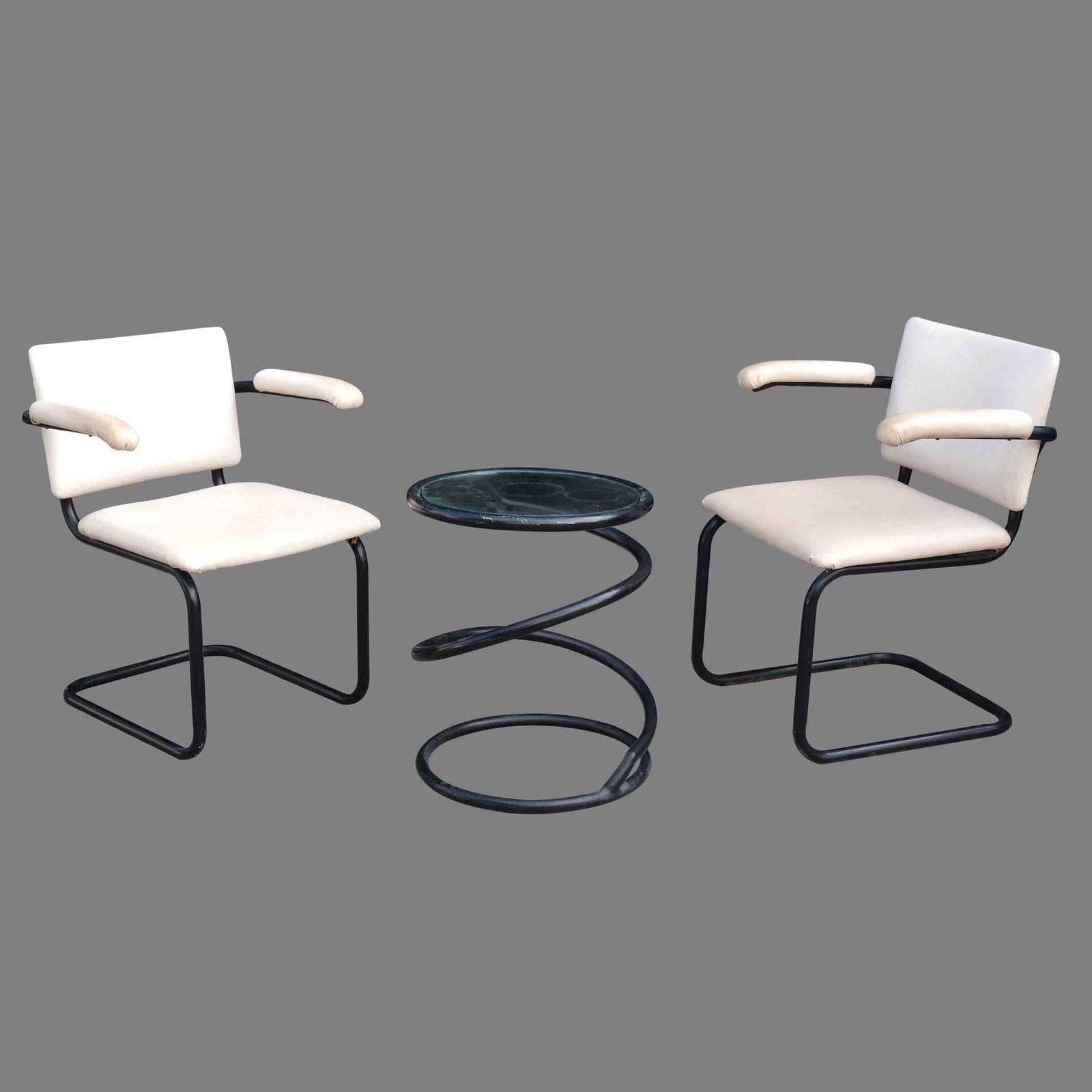 A Pair of Cantilever Chairs and a Table: steel and faux leatherchairs: 30 1/2” x 20” x 23”(77 cm x 51 cm x 58 cm) eachtable: H: 22” (56 cm) D: 18 1/2” (47 cm)