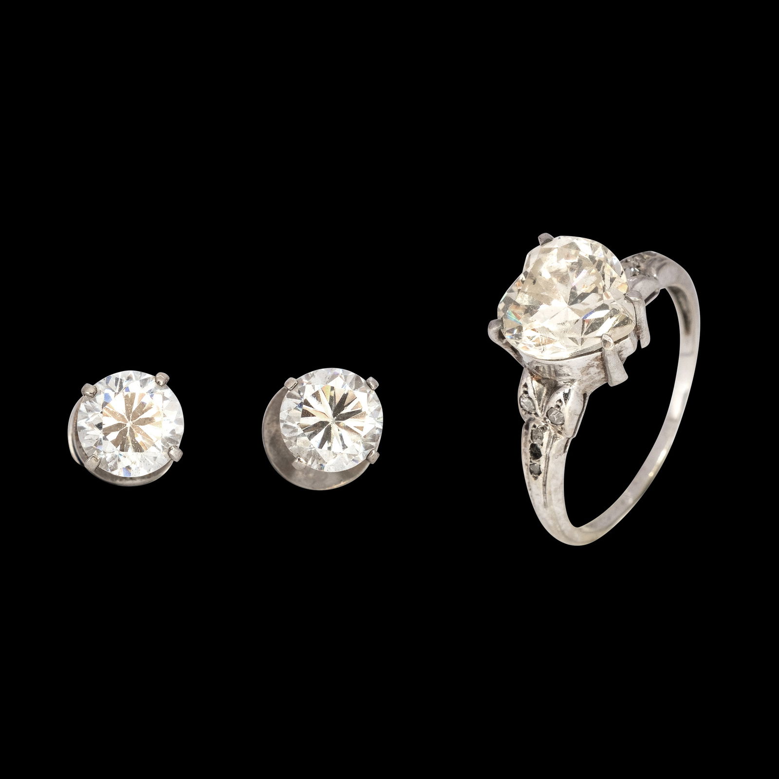 A Set of 14k Jewelry: A set of crystal jewelry in 14k white gold,comprising earrings and a matching ring. The piece is hallmarked 18k and signed Wood. Weighs 4.0 and 3.20 grams.