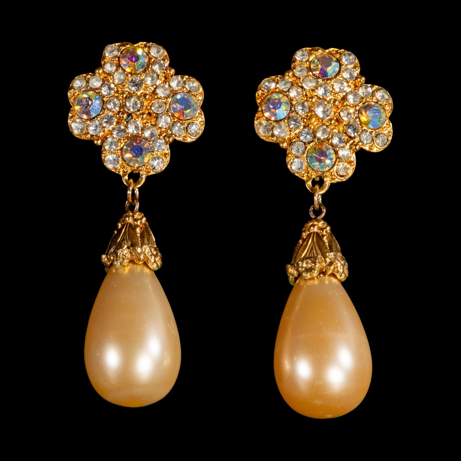 A Pair of Crystal and Faux Pearl Dangling Earrings: The pair of gold-plated dangling earringsfeature clover-shaped studs encrusted withfoil-back crystals, from which large faux pearlssuspend. Weighs 49.60 grams.