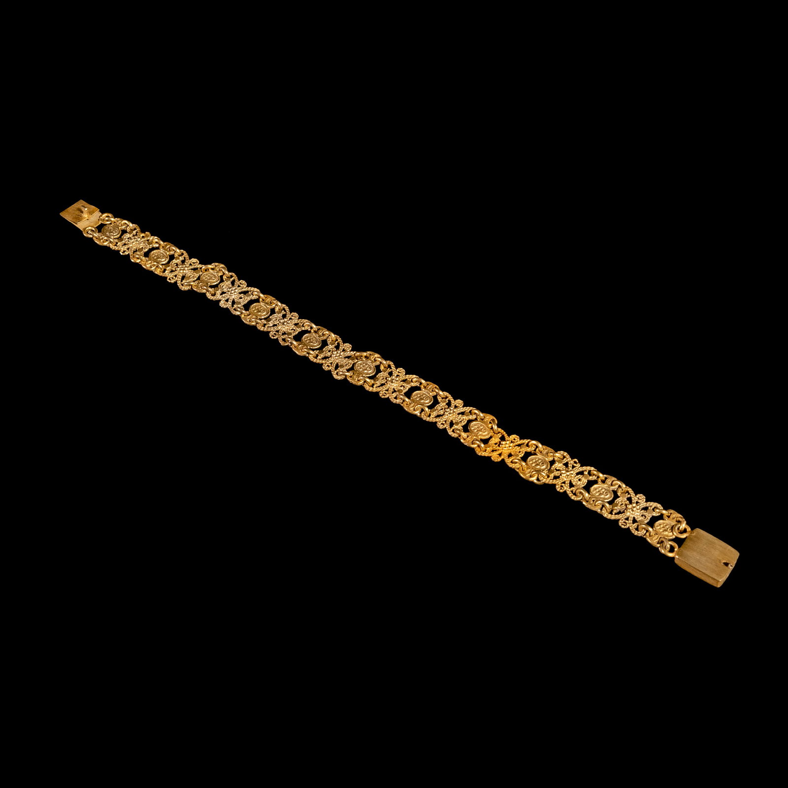 An Intricate Flat-fold Tamburin Bracelet: The silver bracelet showcases flat-fold linksadorned with intricate filigree detailing Weighs 10.30 grams. The bracelet length is 7 inches.