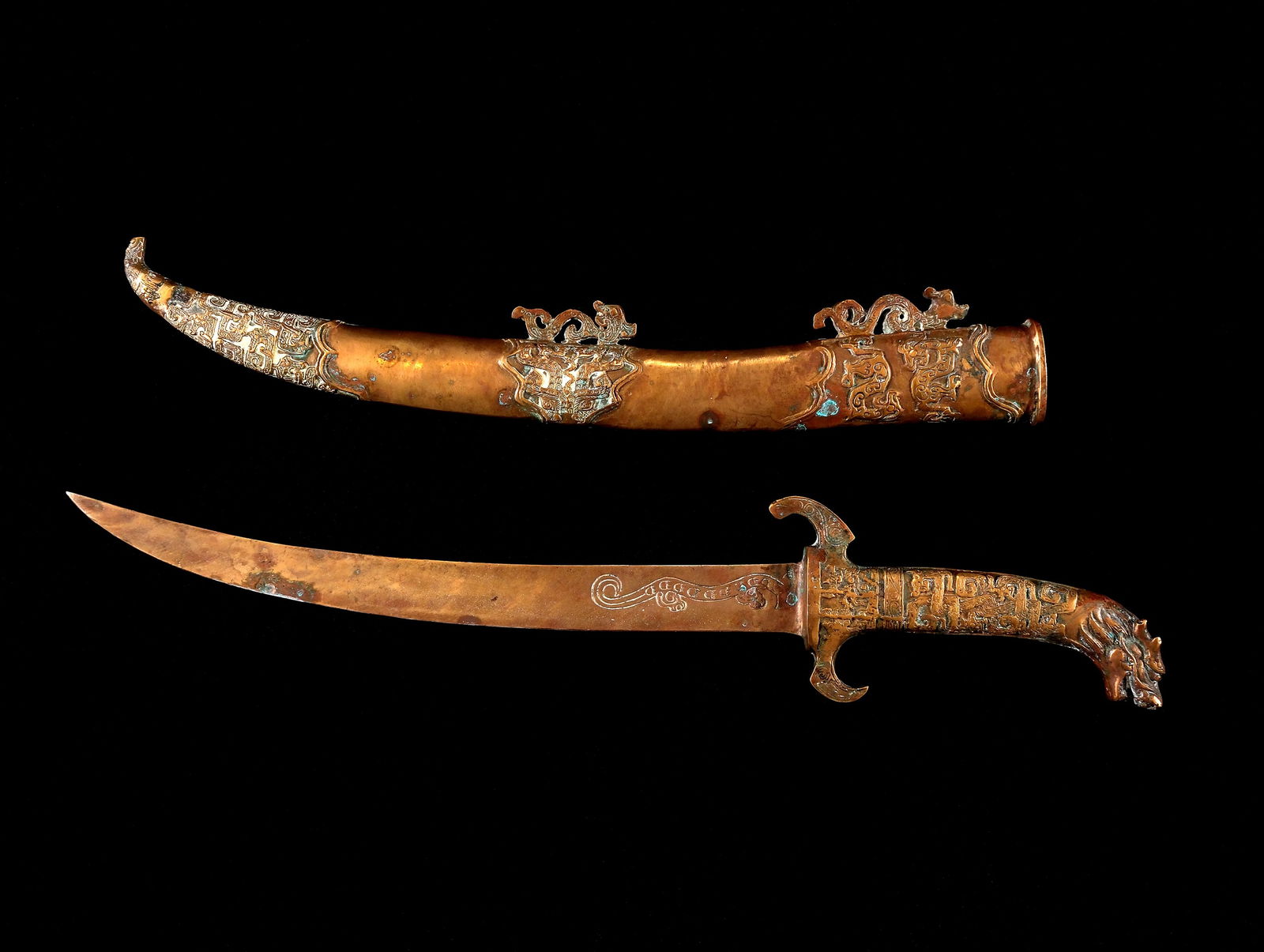 A Decorative Dagger: dagger:L: 21 1/4” (54 cm)W: 4” (10 cm) scabbard:L: 17 1/2” (44 cm)W: 2 3/4” (7 cm)