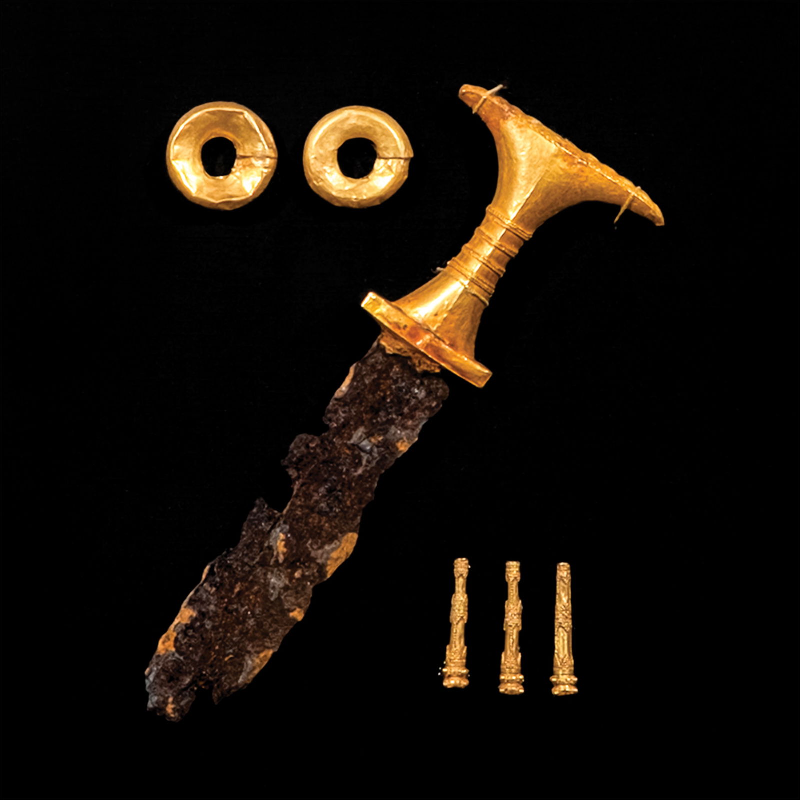 Philippine Pre-Colonial Gold: Framed precolonial gold ornaments consisting of twogold earrings with visible markings of goldwork; adagger with a gold hilt with fine filigreed decorations;and three gold pendant ornaments with filig