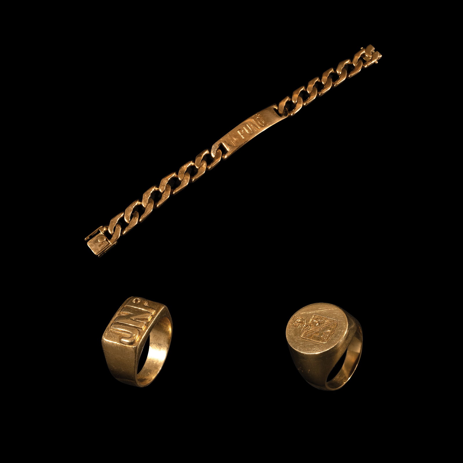 A Collection of Bracelet and Rings: PROPERTY FROM THE PEÑA - OLONDRIZ COLLECTION a.) A Curb-link ID Bracelet in 18k The curb-link ID bracelet in 18k yellow gold features a central ID plate personalized with the engraving “Puno”