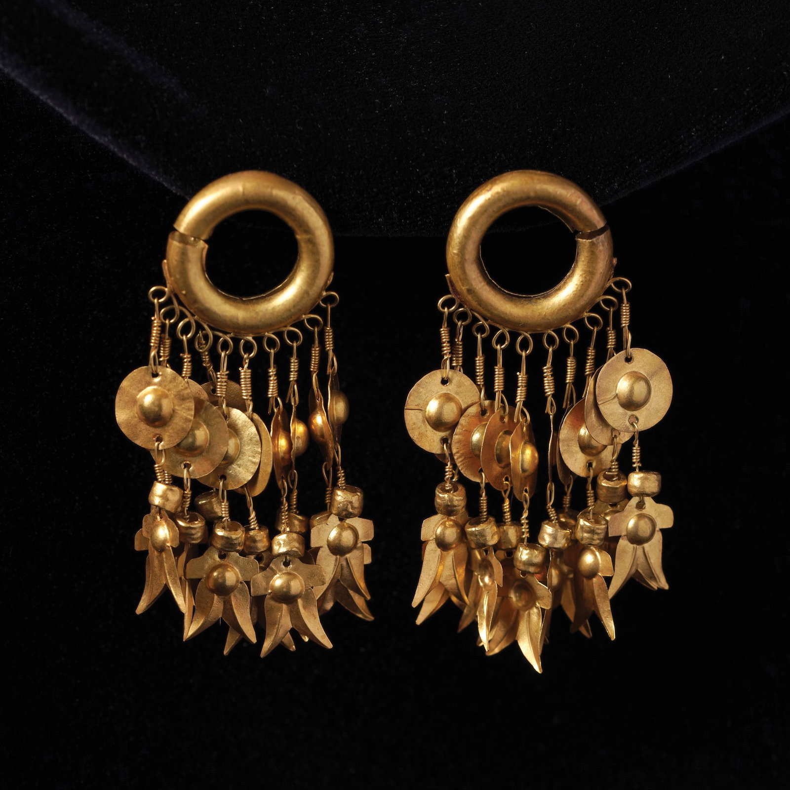Pair of Filipino Pre-Colonial Gold Earrings: PROPERTY FROM THE MA. CRISTINA O. ROXAS COLLECTION 12th–15th century CE Butuan / Agusan–Surigao cultural sphere, northeastern Mindanao. Materials: Gold; later pin fittings by Ramon Nazareth Villeg