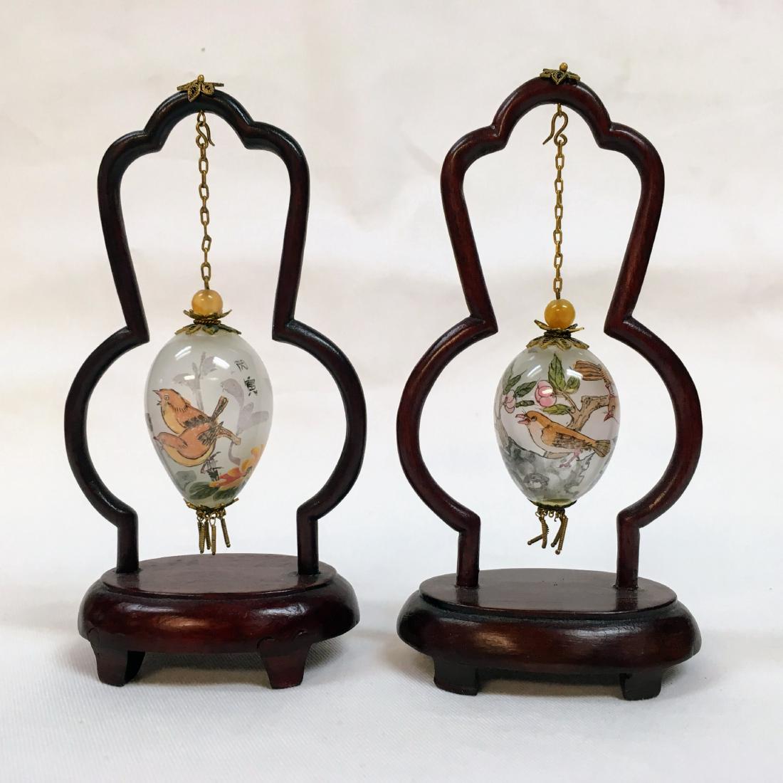 Set of 2 Chinese reverse painting glass eggs on bases (1 of 3)