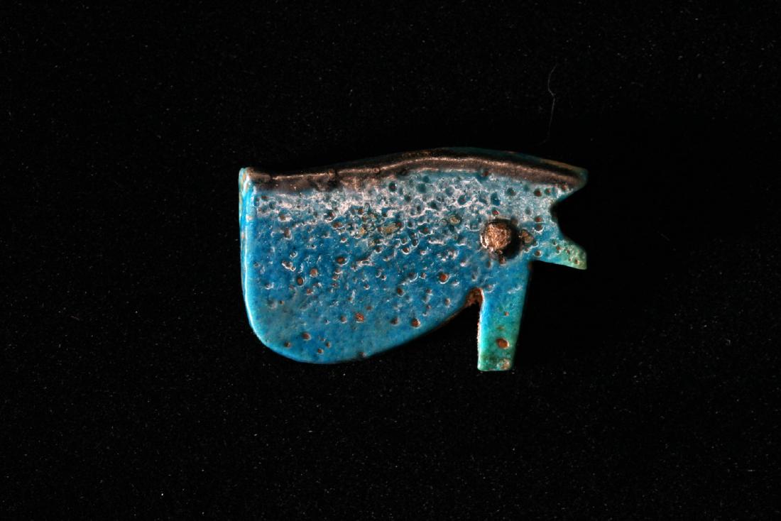 A Large Egyptian Faience Eye of Horus: Egypt; Late Period, 716-30 BCRich, glossy blue with black accents. Very nice size. 1 - 3/8" (3.5 cm) Provenance: The John J. Slocum Collection Mr. Slocum (1914-1997) collected most of his antiquities