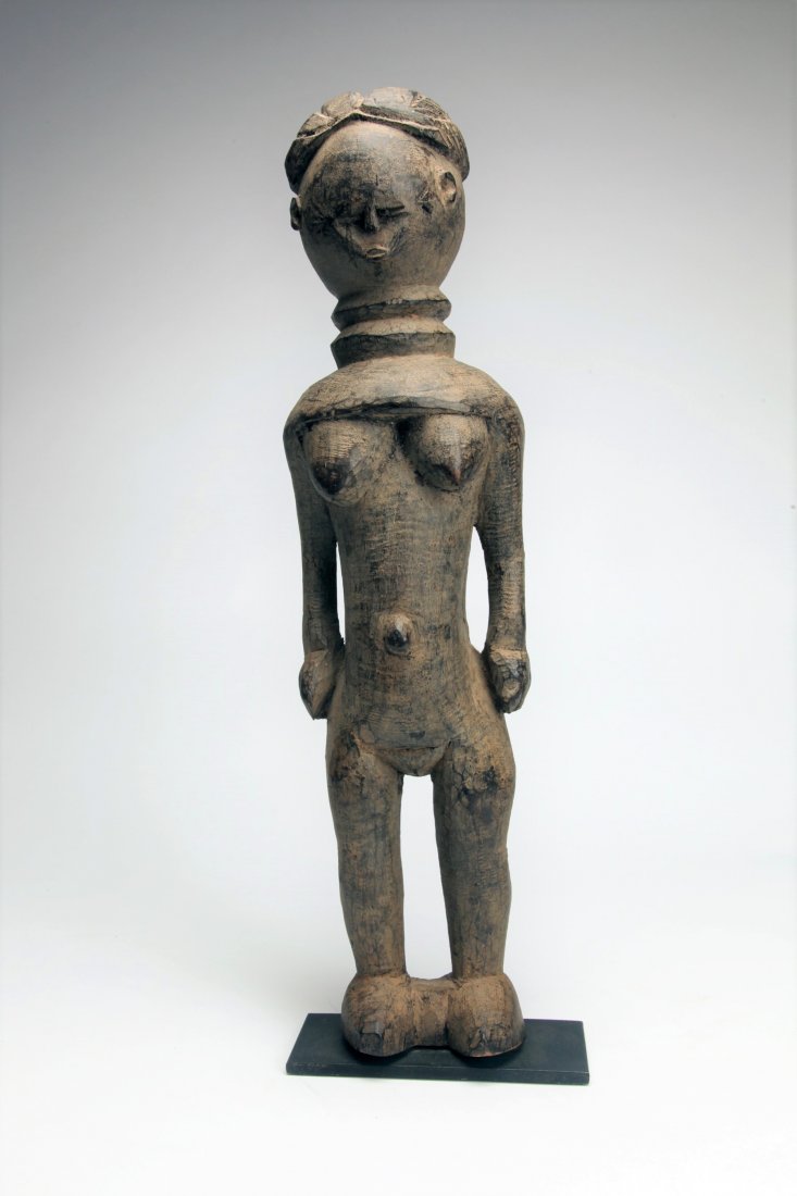 Early African Wood Female Figure: Sierra Leone; Minde Tribe. A wood female ancestor figure of stylized form. Old auction tag under custom base. 19.25" (48 cm) Willis Henry Auction, 1980's.